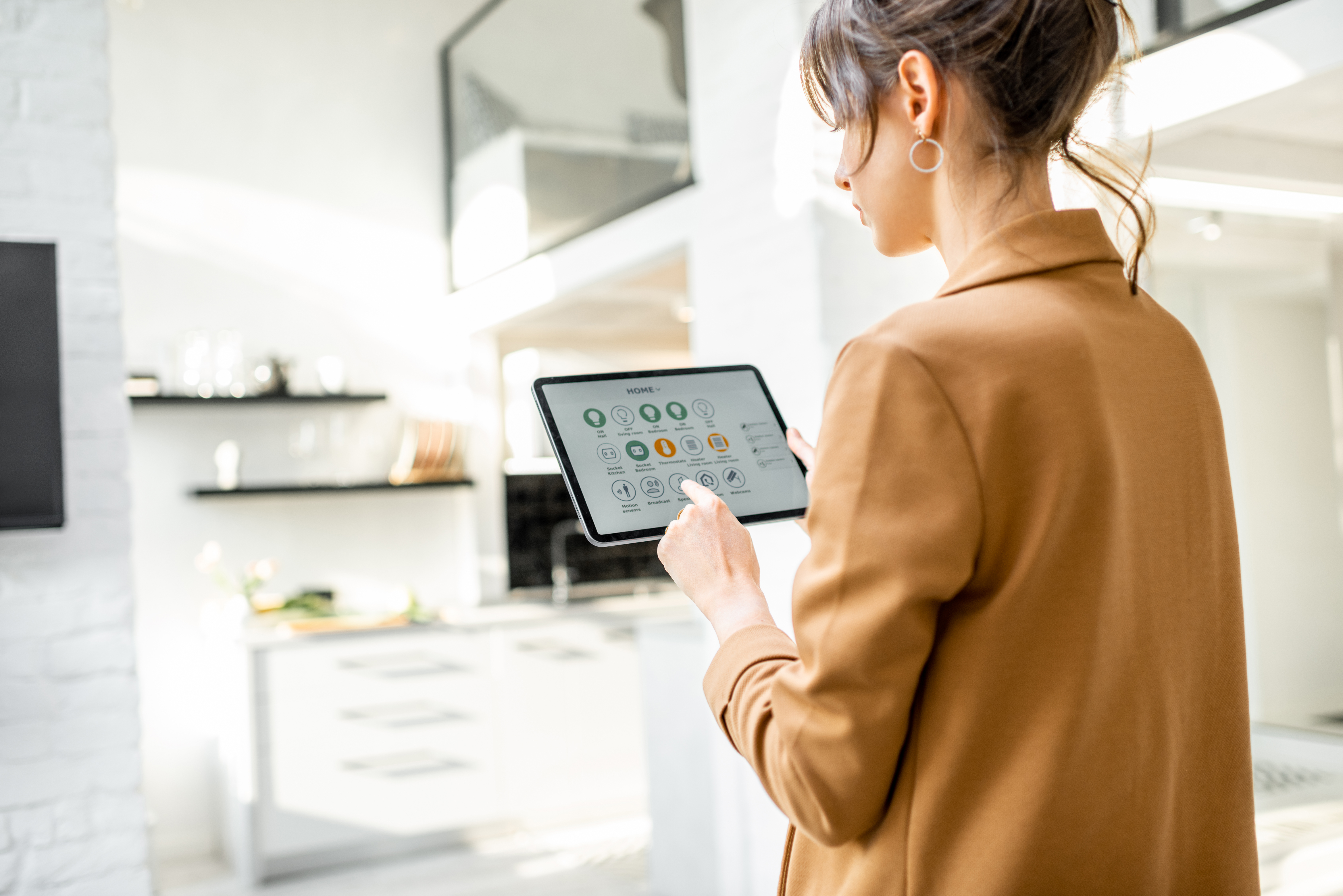 Woman controlling home temperature climate on tablet